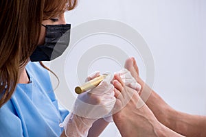 Podiatrist treating feet during procedure