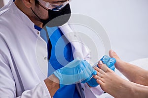 Podiatrist treating feet during procedure