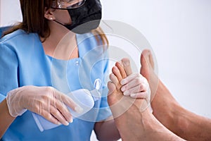 Podiatrist treating feet during procedure