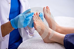 Podiatrist treating feet during procedure