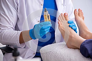 Podiatrist treating feet during procedure