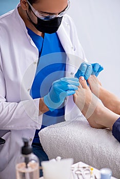 Podiatrist treating feet during procedure