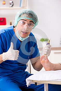 The podiatrist treating feet during procedure