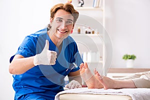 The podiatrist treating feet during procedure