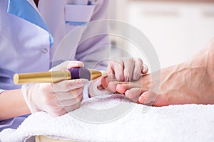 The podiatrist treating feet during procedure