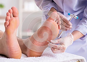 Podiatrist treating feet during procedure