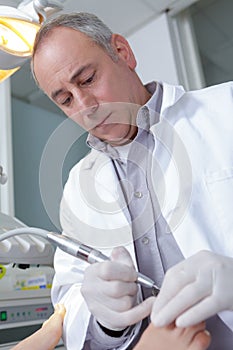 Podiatrist working on patient in clinic