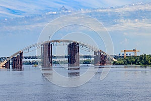 Podilsko-Voskresenskyi Bridge or Podilskyi Metro Bridge is a combined road-rail bridge over the Dnieper River under construction