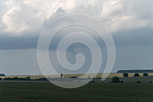 Podolia region, Ukraine. Landscape with dramatic clouds over agricultural field