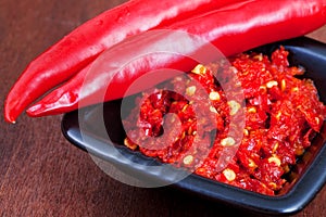 Pods of red hot pepper and spicy sause