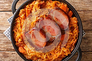 Podvarak Traditional Dish from Balkan Sauerkraut with smoked pork and bacon closeup in the pan. horizontal top view