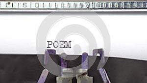 Poem word closeup being typing and centered on a sheet of paper on old vintage typewriter mechanical
