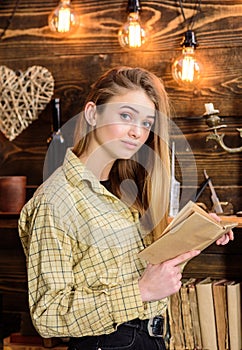 Poetry evening concept. Girl in casual outfit in wooden vintage interior enjoy poetry. Girl reading poetry in warm