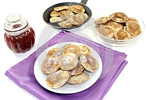 Poffertjes with powdered sugar and fruit jelly