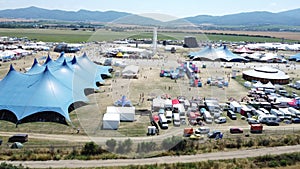 Pohoda Musical Festival 2023 in Slovakia filled with tents and cars in parking lot aerial shot by drone day