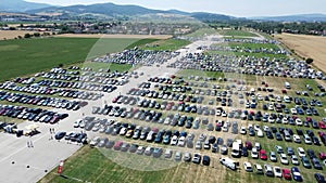 Pohoda Musical Festival 2023 in Slovakia filled with tents and cars in parking lot aerial shot by drone day