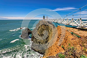 Point Bonita Lighthouse on the rock under blue sky, California