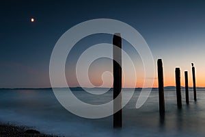 Point Roberts pilings and silky water at night time photo