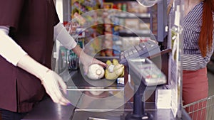 Point of sale.Cashier scans purchase products