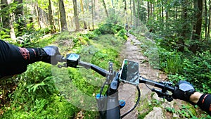 Point of view. Cyclist riding electric mountain bikes outdoors.