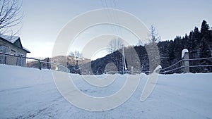 Point of view from drive`s side, vehicle driving on snowy mountain road.