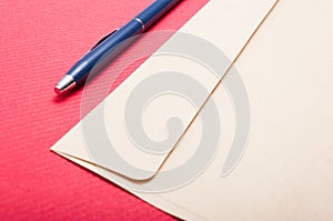 Point of view of envelop and pen on office table