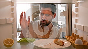 Point of view from inside refrigerator POV Caucasian adult man householder homeowner open fridge door kitchen smell