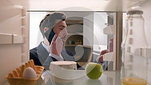 Point of view POV inside refrigerator Caucasian businessman employer busy man open fridge with one egg, apple and empty