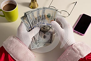 Point of view of Santa Claus hands holding money, dollars