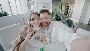 Point of view shot of attractive loving couple recording video while relaxing in day spa together. Young people are