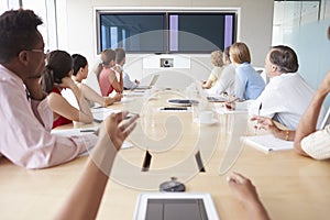 Point Of View Shot Of Businesspeople Around Boardroom Table