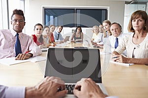 Point Of View Shot Of Businesspeople Around Boardroom Table