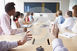 Point Of View Shot Of Businesspeople Around Boardroom Table