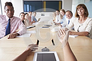 Point Of View Shot Of Businesspeople Around Boardroom Table