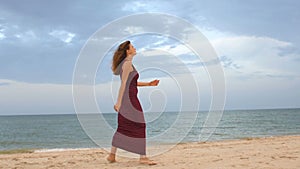Point of view of young woman stepping at the golden sand at sea beach. Female legs walking near ocean. Bare foot of girl going on