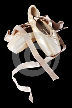 Pointe ballet shoes on black background