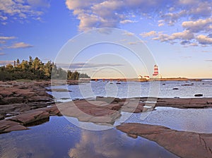 Pointe-des-Monts Lighthouse at sunset, Cote-Nord, Quebec photo