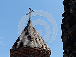 Pointed bell tower of a medieval church of Saint George of Sighnaghi in Georgia.