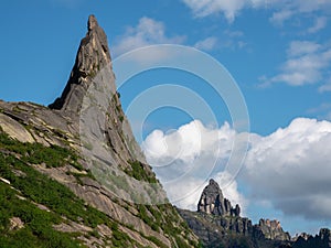 Pointed cliff, a misty mountainside. Ghost rocks. Awesome scenic mountain landscape with big cracked pointed stones closeup in