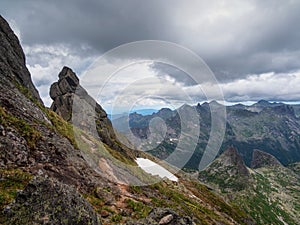 Pointed cliffs mountainside. Ghost rocks. Awesome scenic mountain landscape with big cracked pointed stones in misty rainy morning