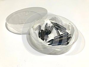 Pointed nibs kept in a plastic container