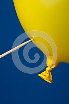 A pointed stickand a yellow balloon on b