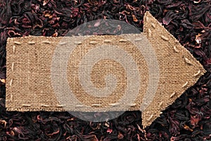 Pointer of burlap lies on hibiscus