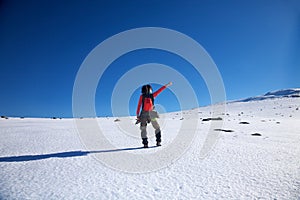 Pointing red hiking woman