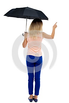 Pointing woman under an umbrella