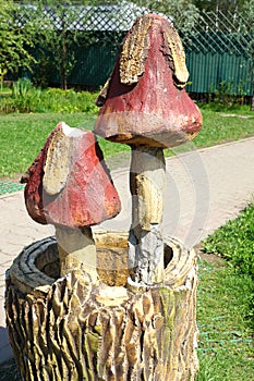 Poisonous mushrooms on hemp. Small fabulous skulpture in the city park