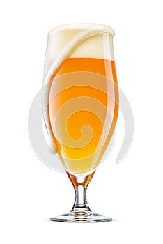 Pokal glass of fresh yellow wheat unfiltered beer with cap of foam overflowing isolated on white
