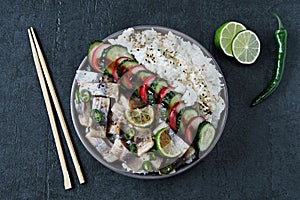 Poke a bowl of herring fillet, vegetables and rice.