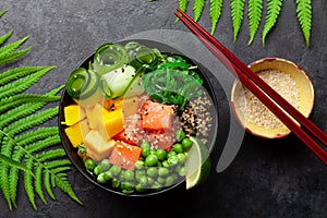 Poke bowl with salmon, cucumber and mango photo