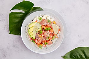 Poke bowl with salmon or tuna, rice, avocado, sesame seeds, micro greens. Hawaiian diet food with fish, pokebowl.